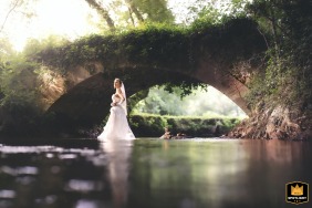   In Lembras, Bergerac district, Dordogne, France, a bride braves getting wet for a truly unique wedding photo filled with fun and spontaneity.